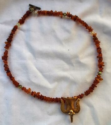 Rough amber nugget/chip beads with an Alva signed pendant.  I performed the marriage