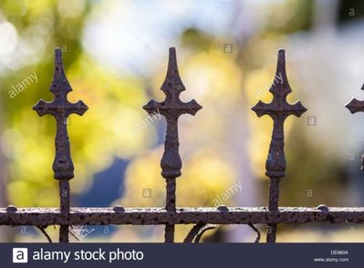 three-crosses-on-top-of-wrought-iron-fence.jpg