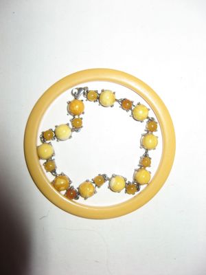 Bakelite spacer, inside it is an amber link bracelet
