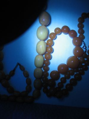 Under UV light, the one on the left is amber, on the right is Bakelite