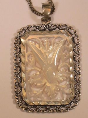 Carved mother of pearl and silver pendant necklace