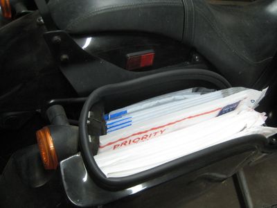 Yep, that's our emergency stash of Priority and eBay branded bubble mailers in the saddlebag. ;-)