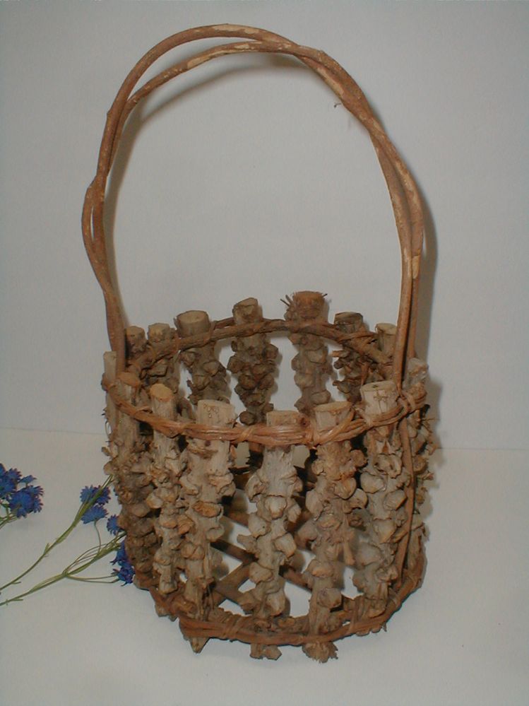Do you know anything about this wooden twig basket? What kind of wood? How old?  What was it used for with its open bottom?  Where was it made?  TIA