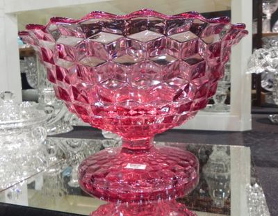 Bowl is about 12 inches high. Scrumptions raspberry color. The $400 price tag put it out of my reach. Nice to look at the photo.