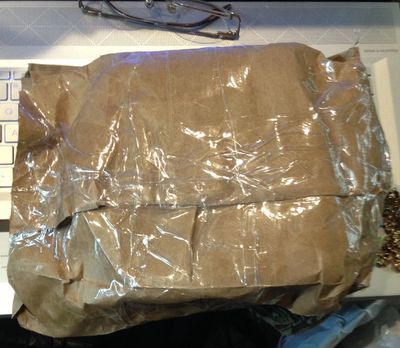 This is a brown paper lunch bag covered in miles of tape